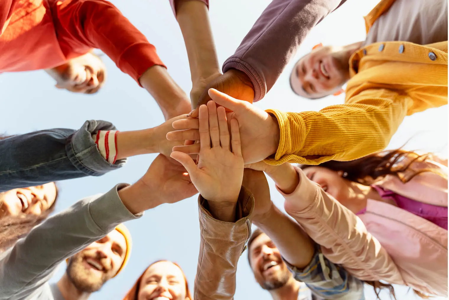Hands joined in a circle, symbolizing unity.
