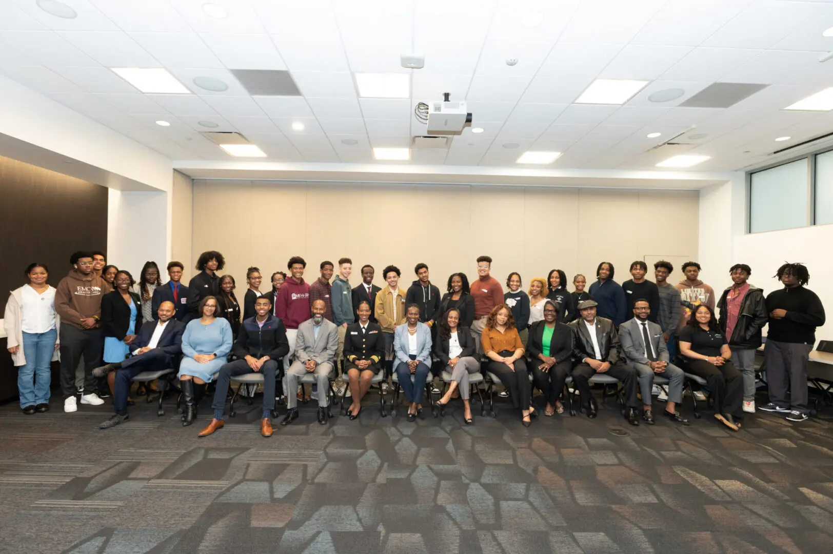 Group photo of people in a conference room.