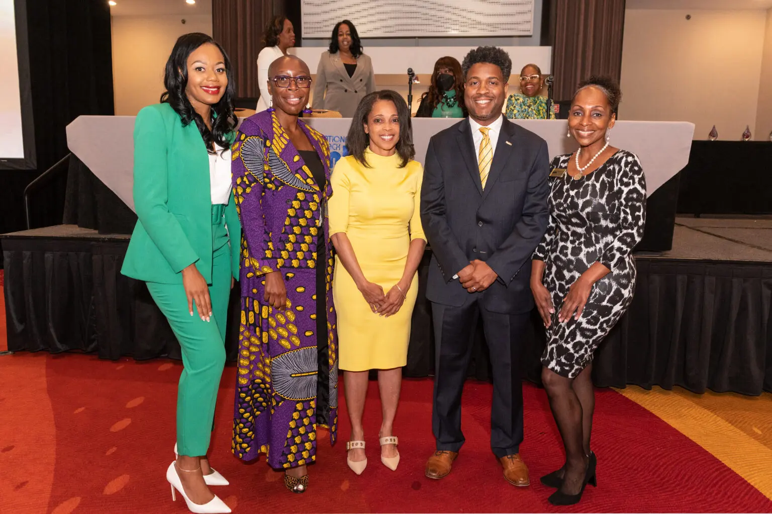 Group of people smiling at an event.