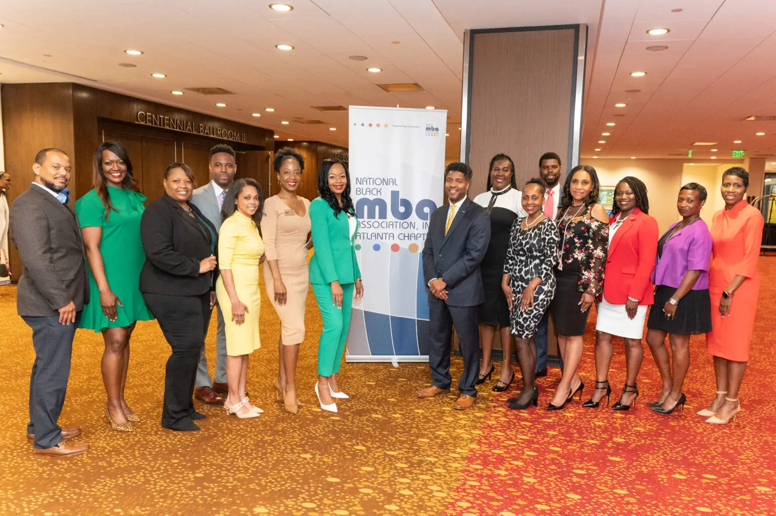 Group of professionals in formal attire posing.