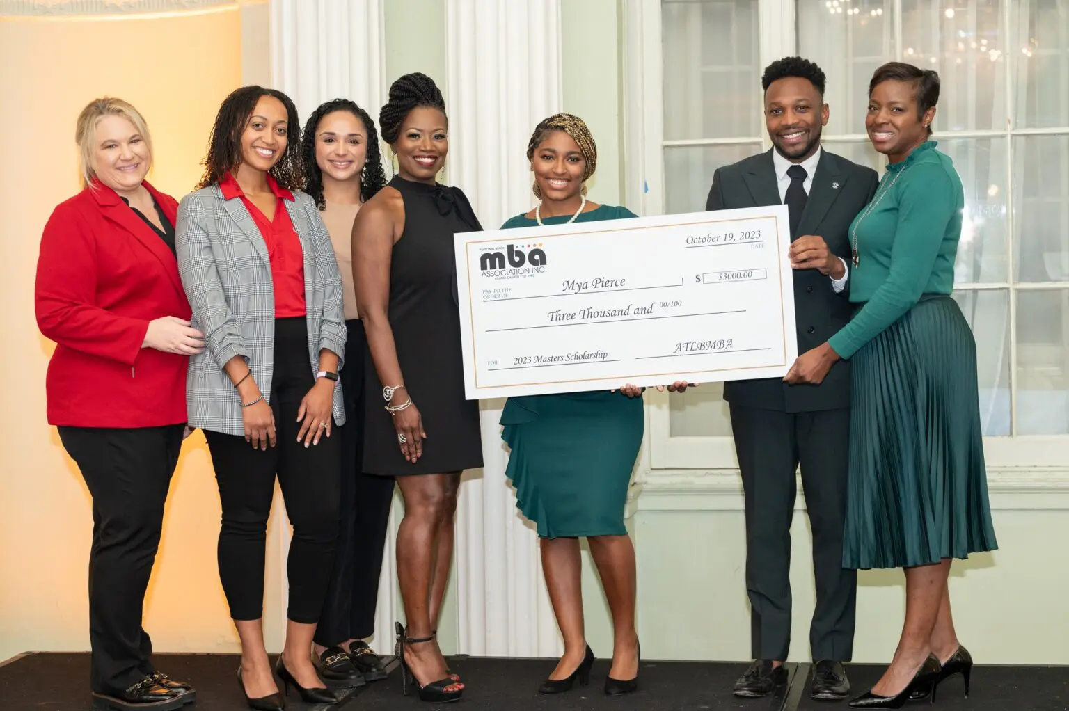 Group holding a large ceremonial check.