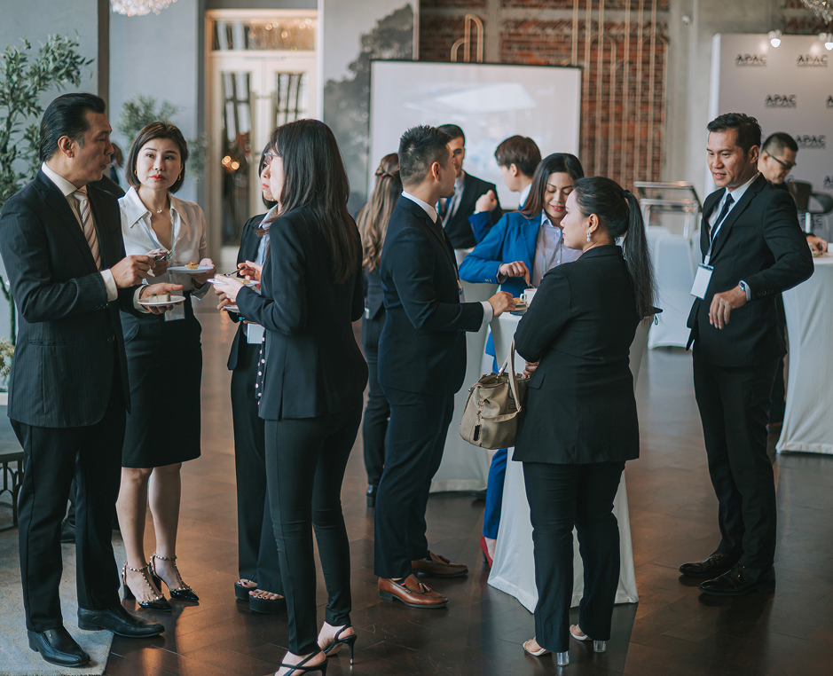 Business professionals networking at a conference event.