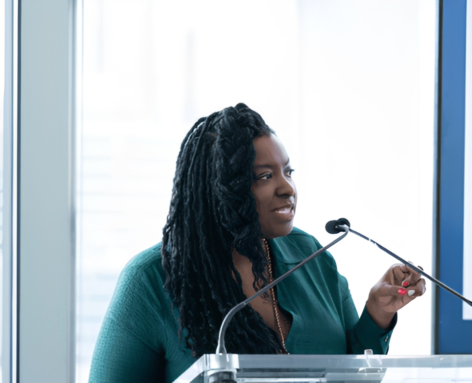 Woman speaking at a podium.