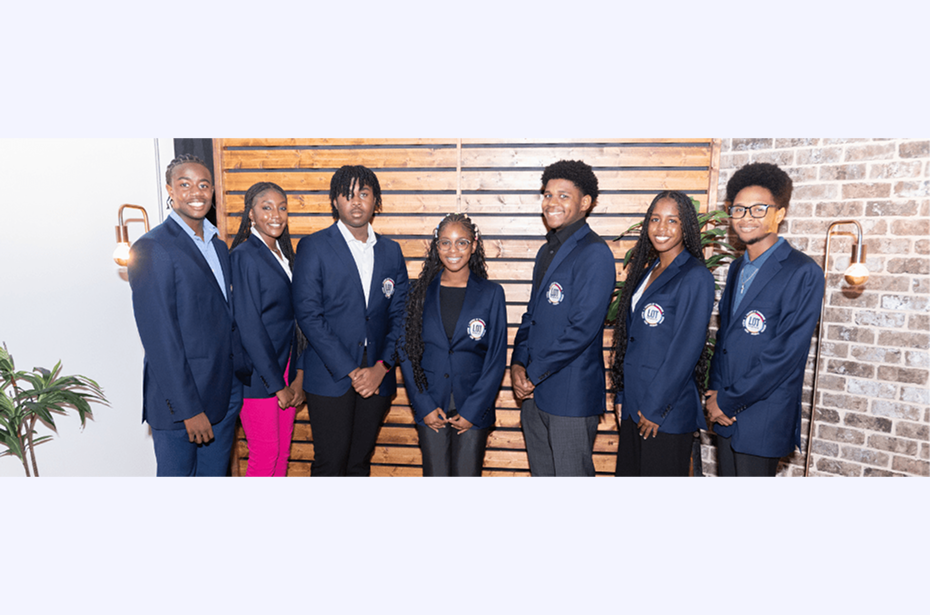 Seven people in matching blue blazers.