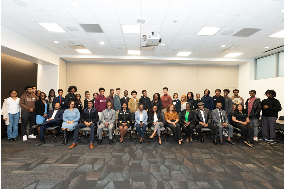 Large group posing in conference room.